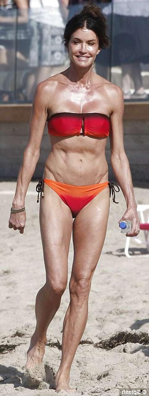 16P Janice Dickinson showing her nice big tits on beach paparazzi pictures