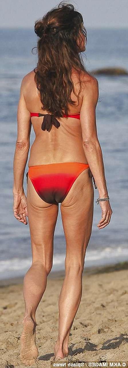 16P Janice Dickinson showing her nice big tits on beach paparazzi pictures