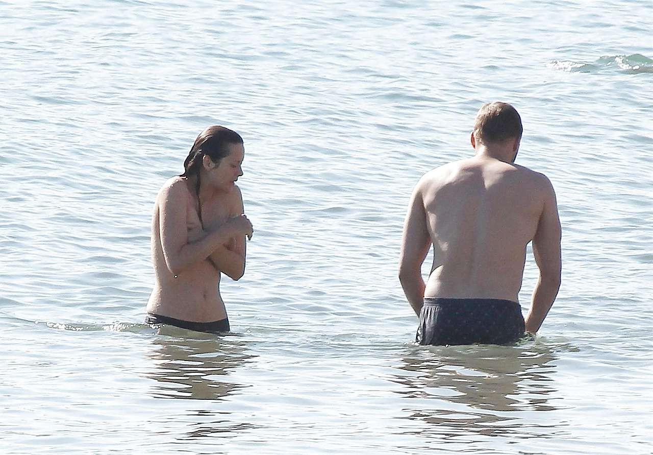 16P Marion Cotillard showing her nice big tits on beach with friend paparazzi pictur