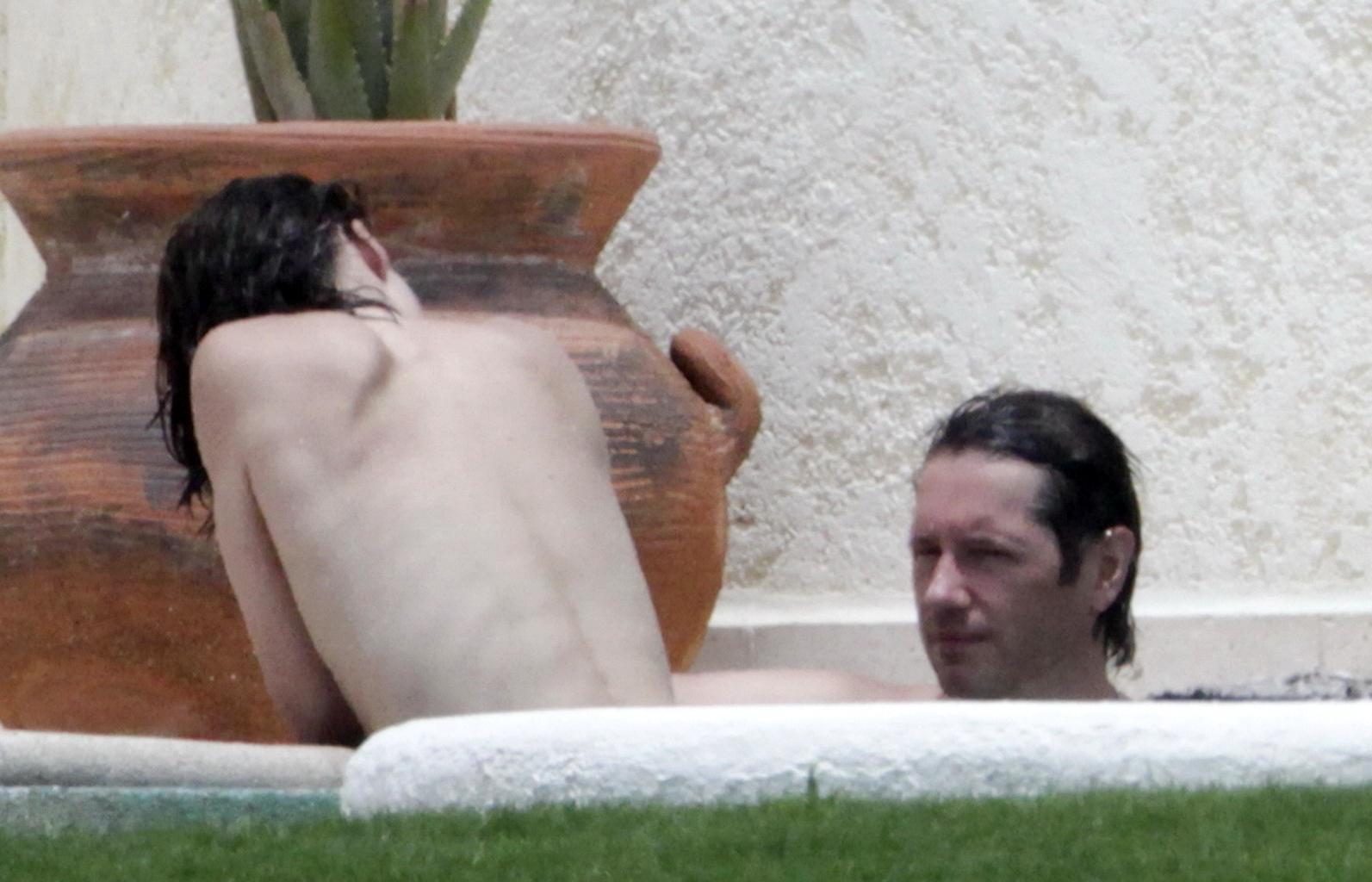 16P Milla Jovovich topless but hiding her boobs in Cabo San Lucas