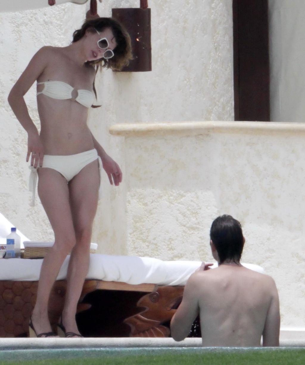 16P Milla Jovovich topless but hiding her boobs in Cabo San Lucas