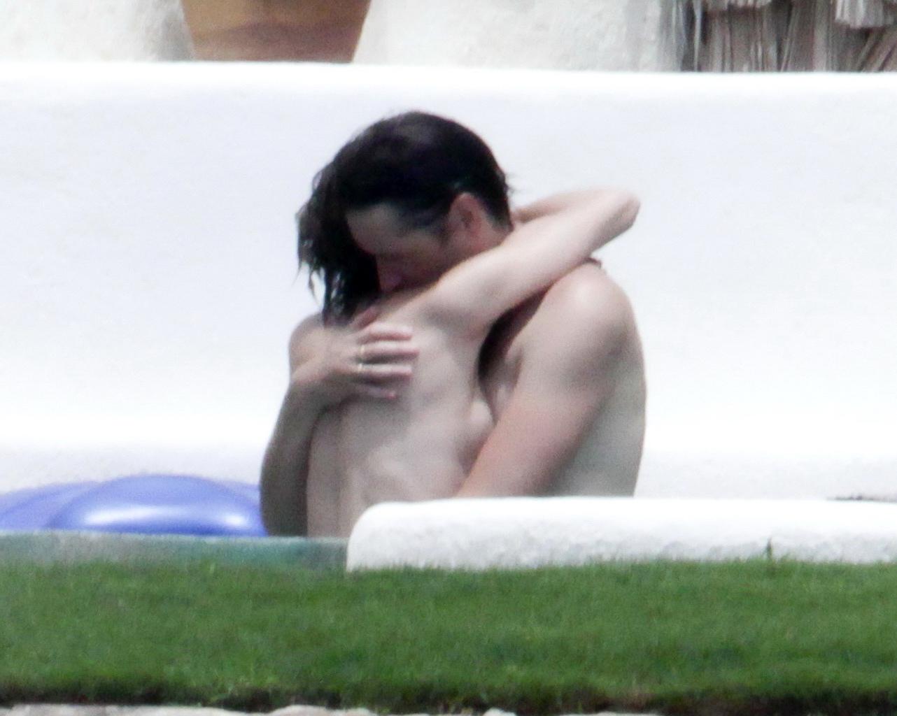 16P Milla Jovovich topless but hiding her boobs in Cabo San Lucas