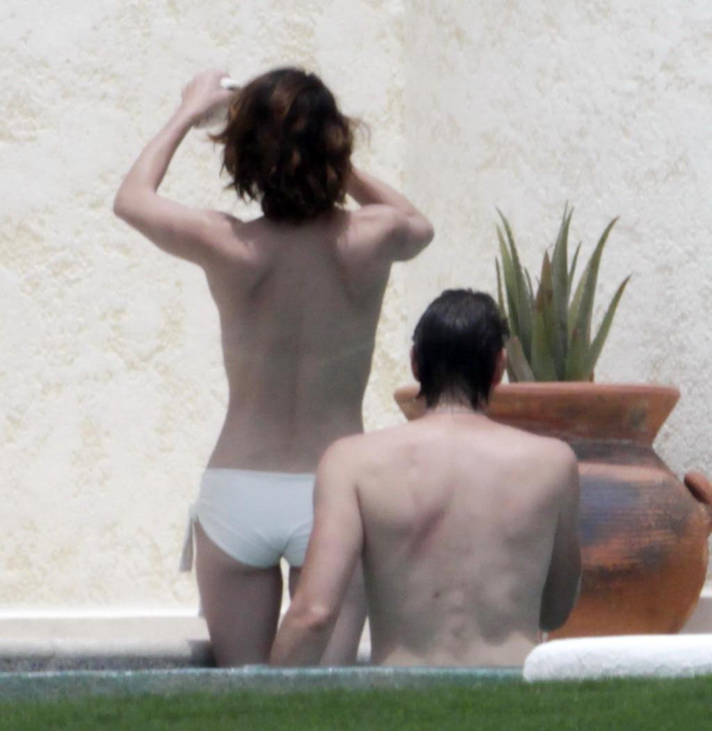 16P Milla Jovovich topless but hiding her boobs in Cabo San Lucas