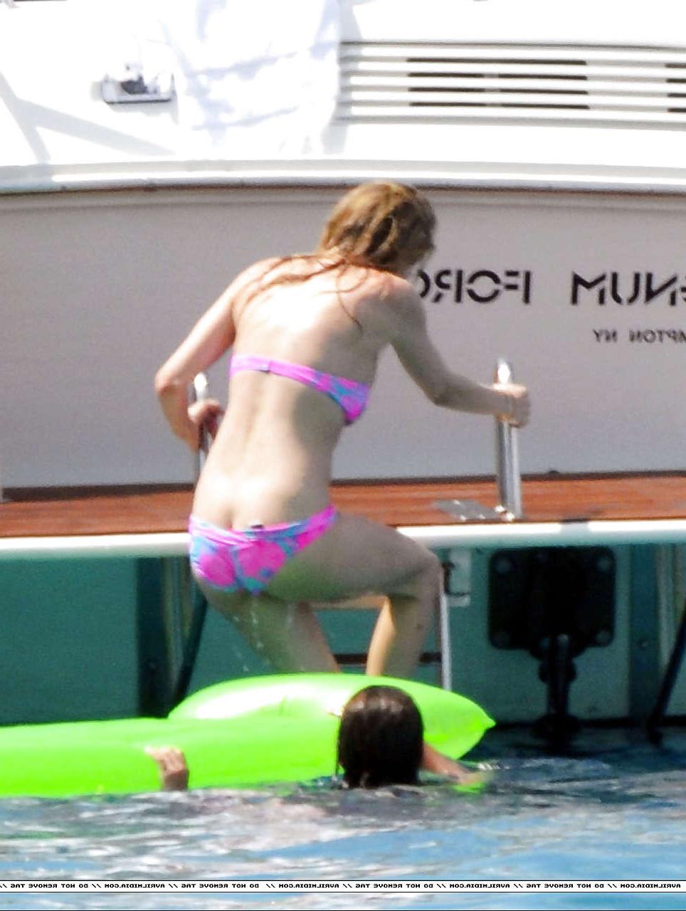 16P Avril Lavigne showing part of her ass and nipple slip in bikini on beach