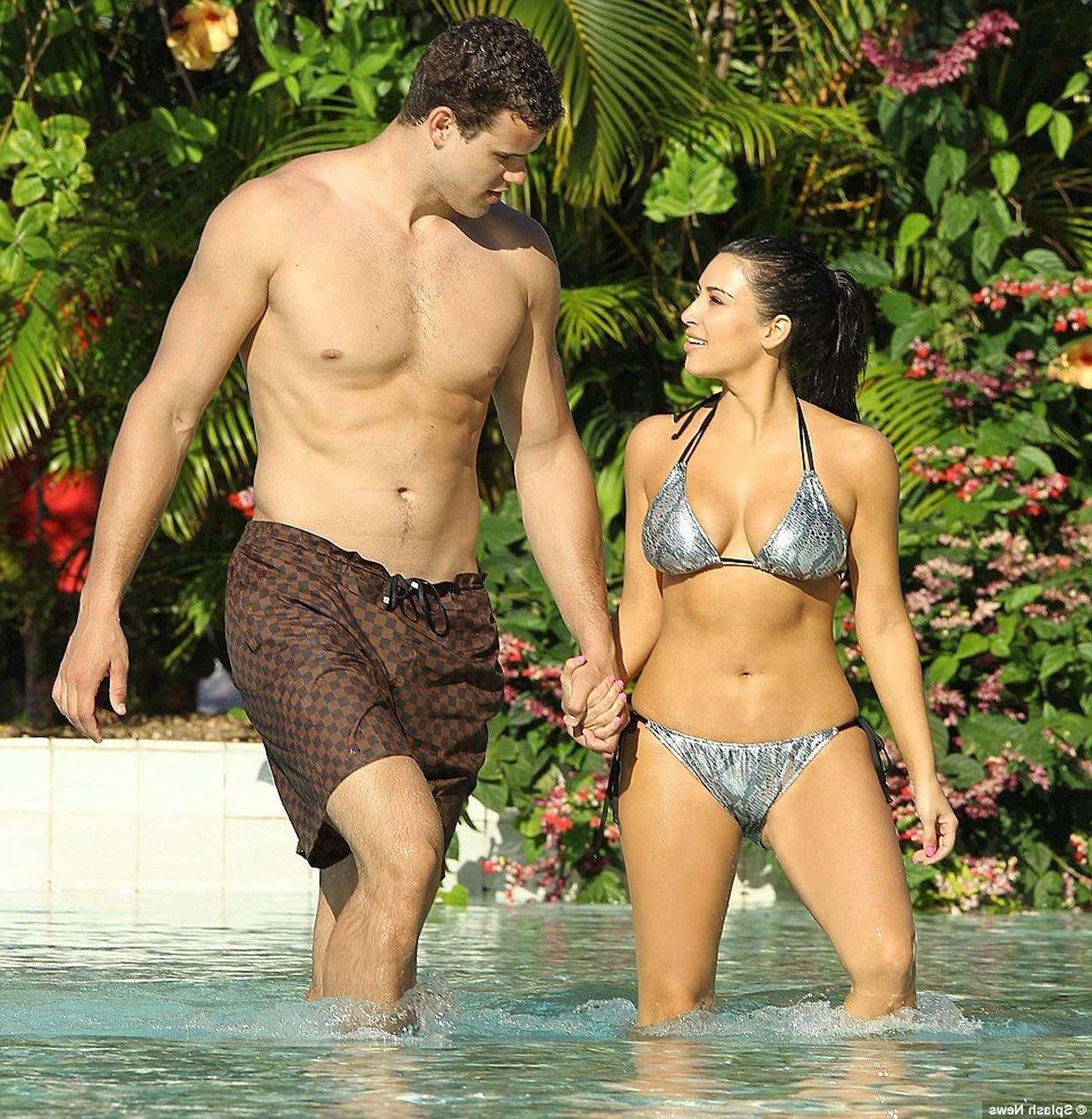 16P Kim Kardashian exposing sexy body and huge boobs in bikini on beach