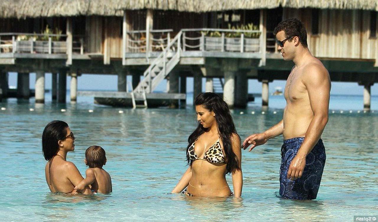 16P Kim Kardashian exposing sexy body and huge boobs in bikini on beach