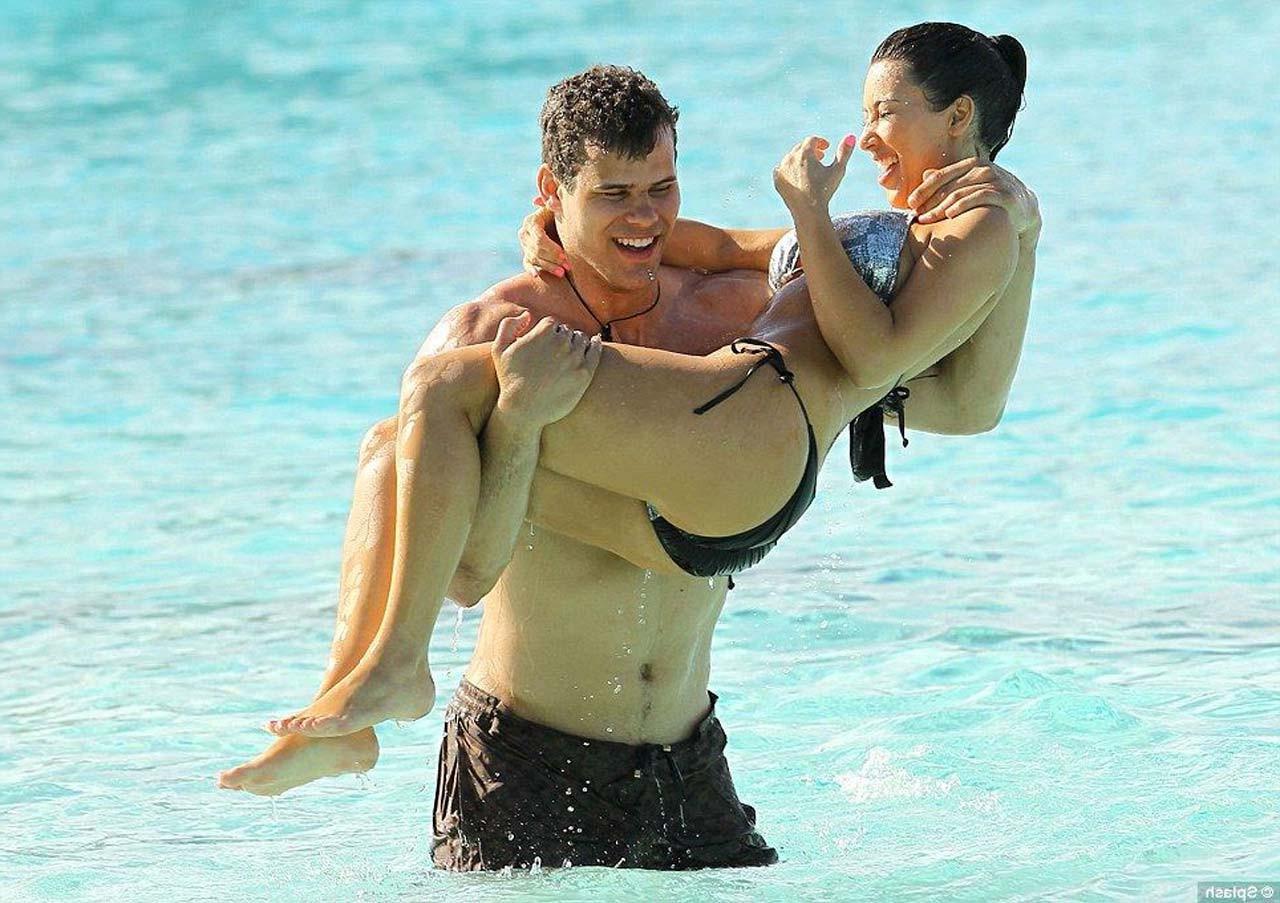 16P Kim Kardashian exposing sexy body and huge boobs in bikini on beach