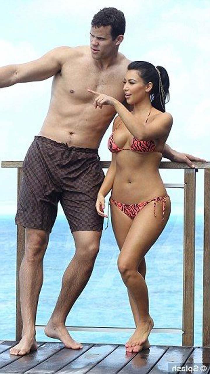 16P Kim Kardashian exposing sexy body and huge boobs in bikini on beach