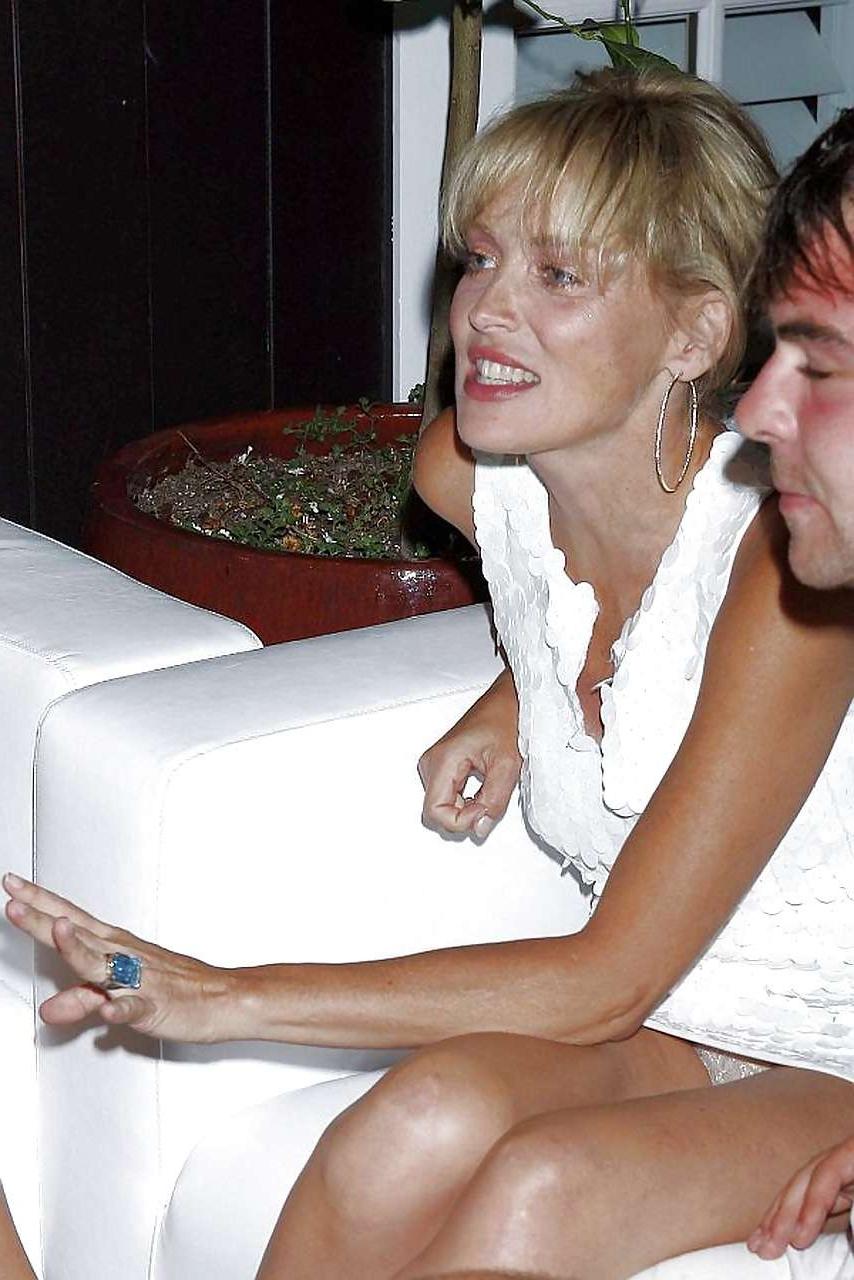 16P Sharon Stone showing her panties upskirt and nice tits in see thru dress paparaz