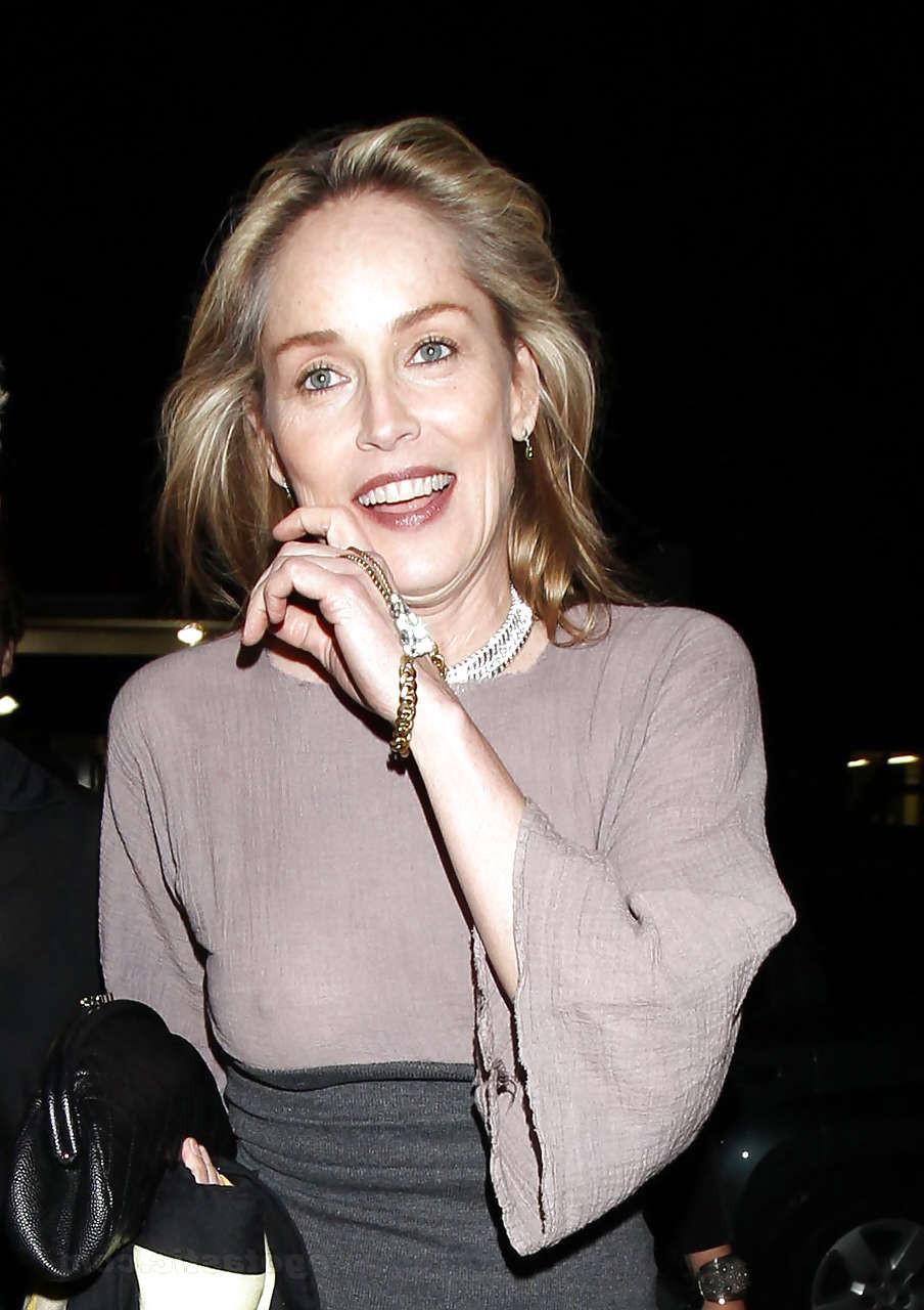 16P Sharon Stone showing her panties upskirt and nice tits in see thru dress paparaz