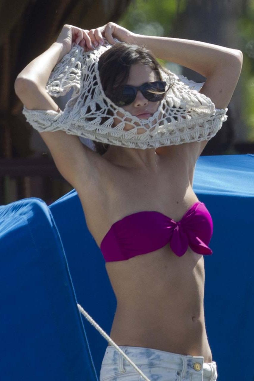 16P Selena Gomez exposing her sexy body and hot ass in bikini on beach
