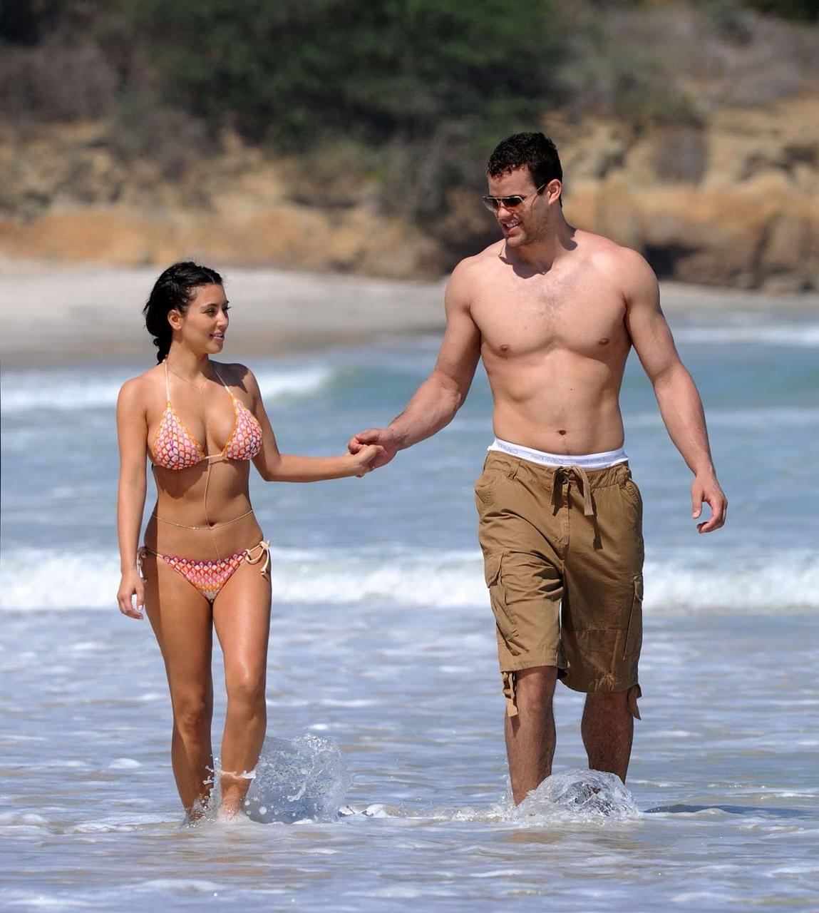 16P Kim Kardashian exposing sexy body and huge boobs in bikini on beach