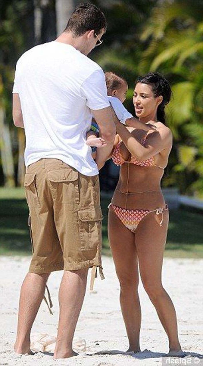 16P Kim Kardashian exposing sexy body and hot ass in bikini on beach
