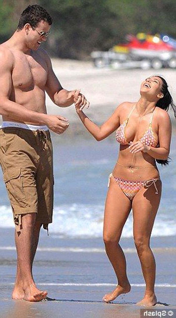 16P Kim Kardashian exposing sexy body and hot ass in bikini on beach