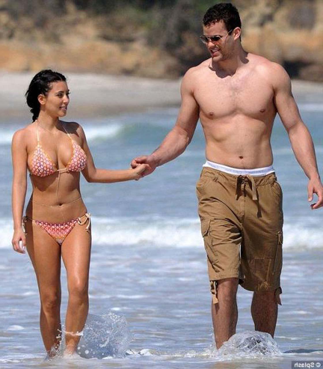 16P Kim Kardashian exposing sexy body and hot ass in bikini on beach