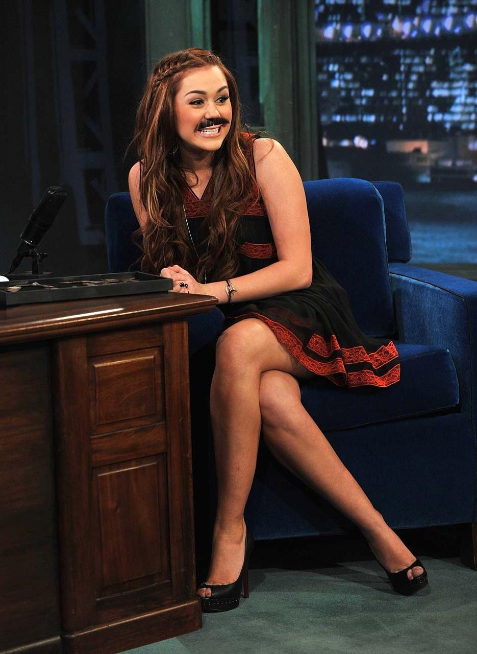 10P Miley Cyrus posing sexy in slutty outfit and showing her great legs in mini dres