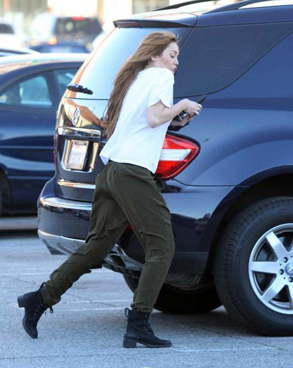 16P Miley Cyrus showing her sexy ass and hard nipples in see thru shirt