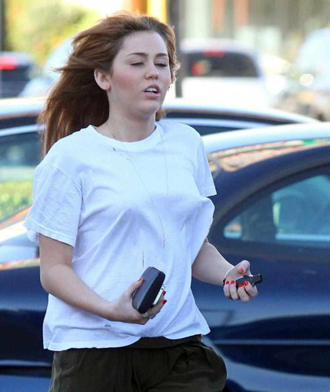 16P Miley Cyrus showing her sexy ass and hard nipples in see thru shirt