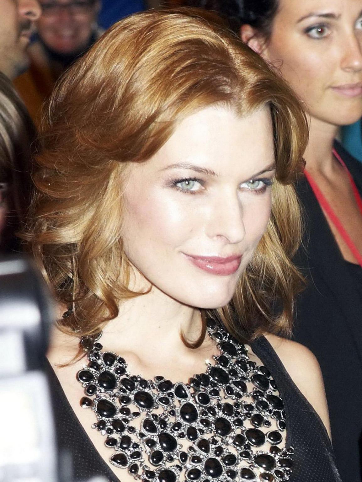 15P Milla Jovovich leggy wearing leather mini dress at the 'Stone' premiere in Toron