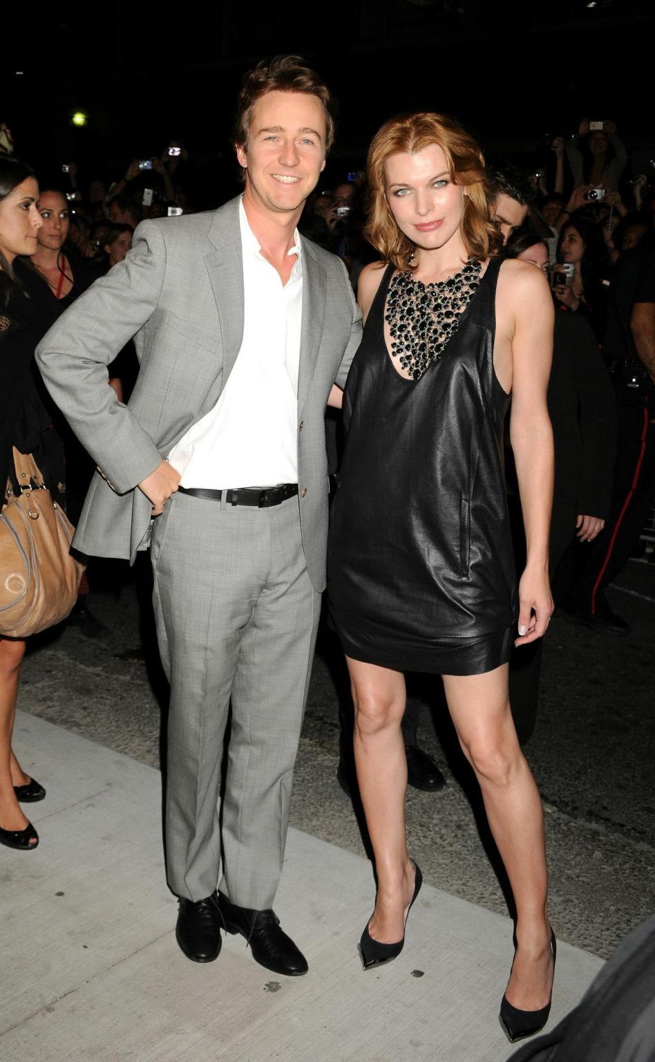 15P Milla Jovovich leggy wearing leather mini dress at the 'Stone' premiere in Toron