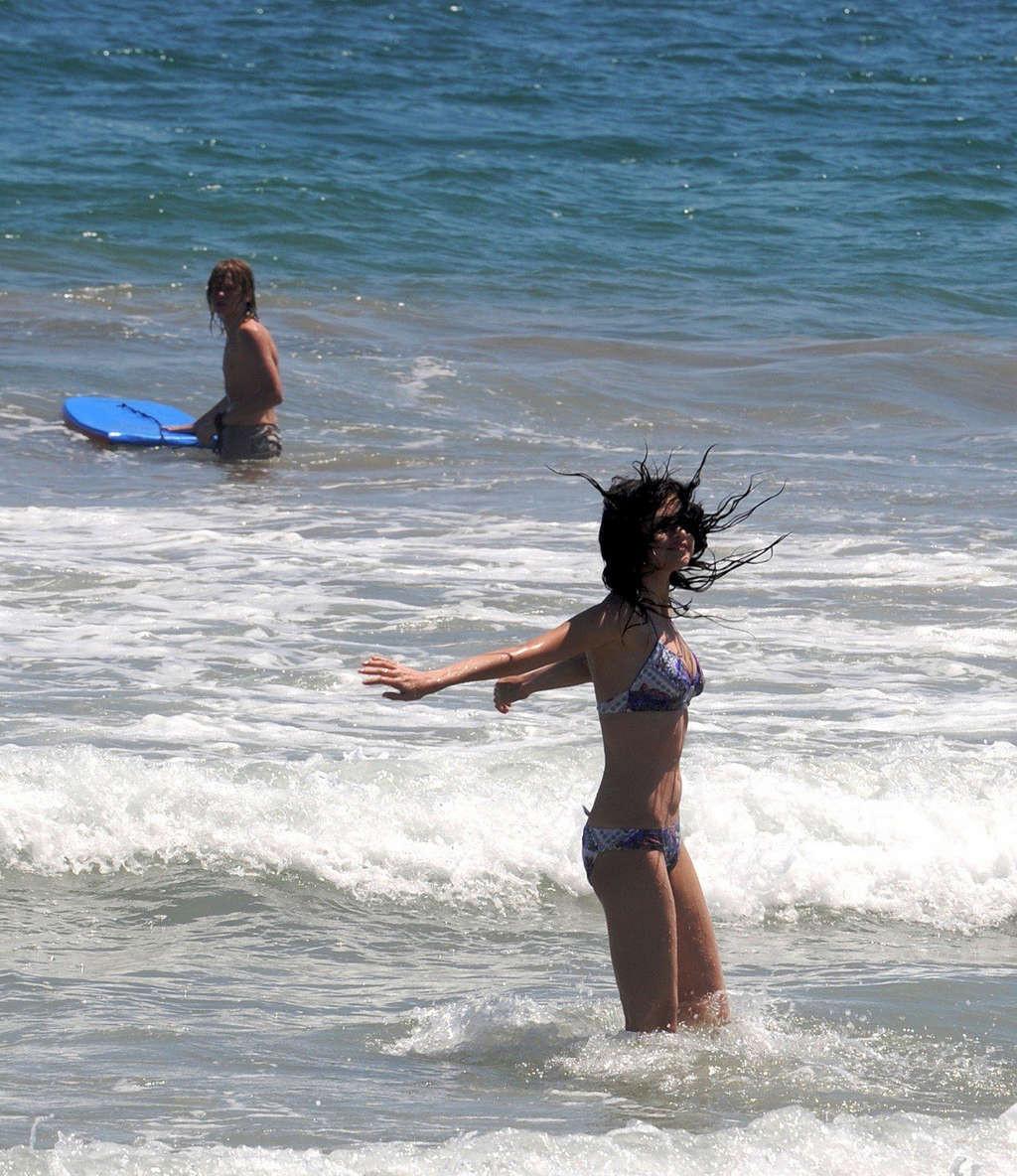 16P Selena Gomez exposing sexy body and hot ass in bikini on beach