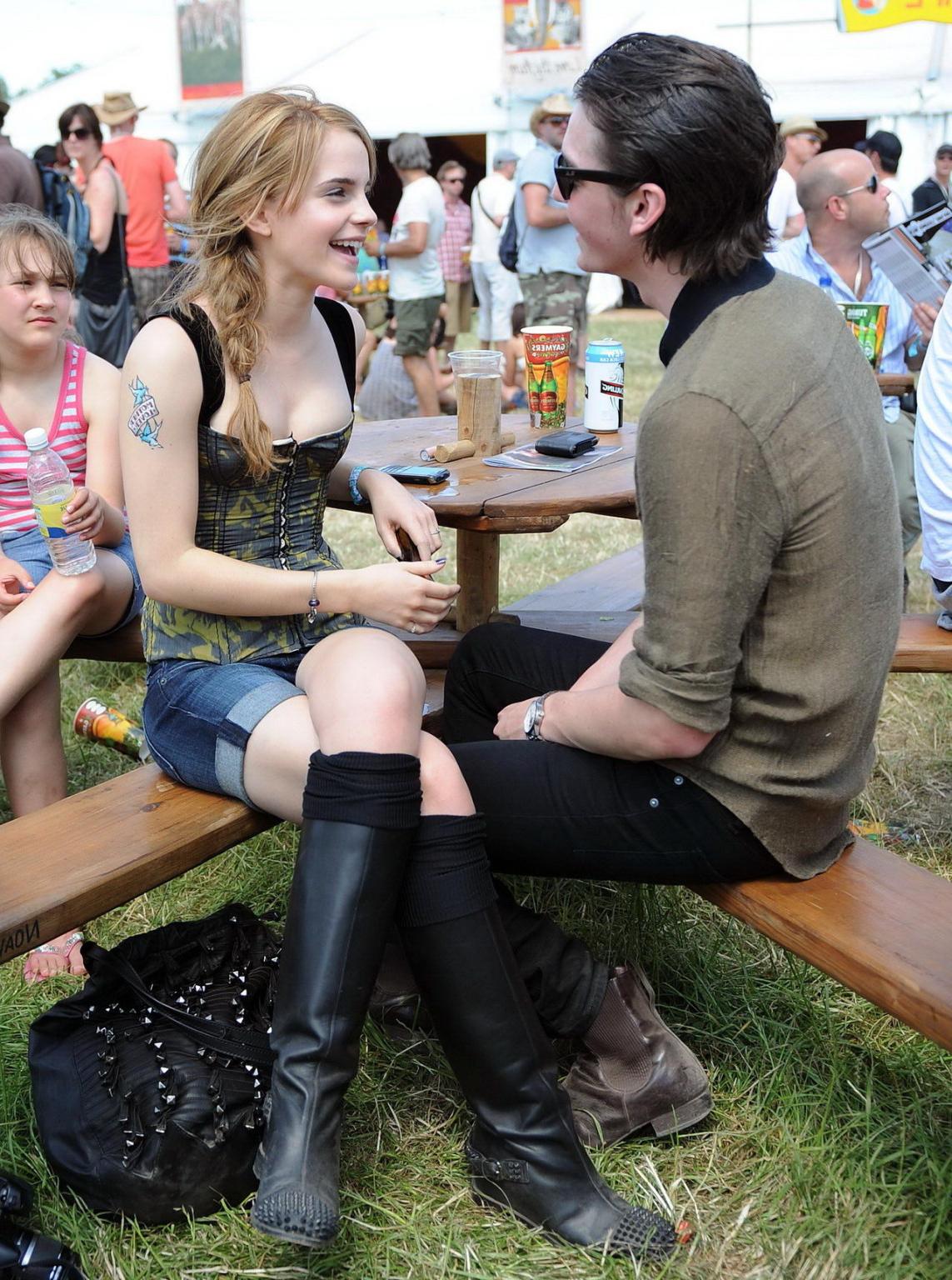 16P Emma Watson leggy  cleavy wearing low cut top, shorts  bots at Glastonbury Music