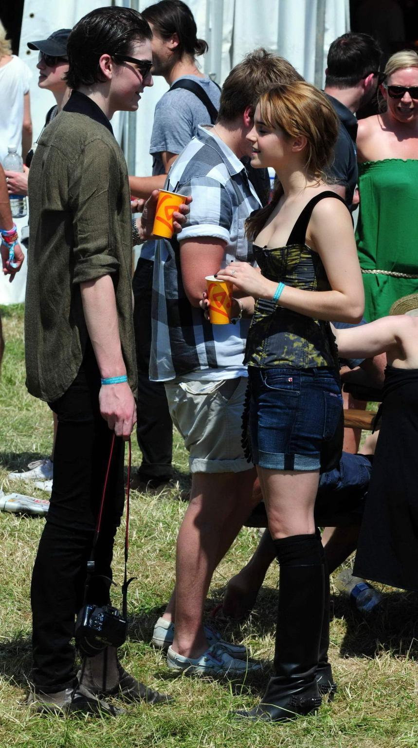 16P Emma Watson leggy  cleavy wearing low cut top, shorts  bots at Glastonbury Music