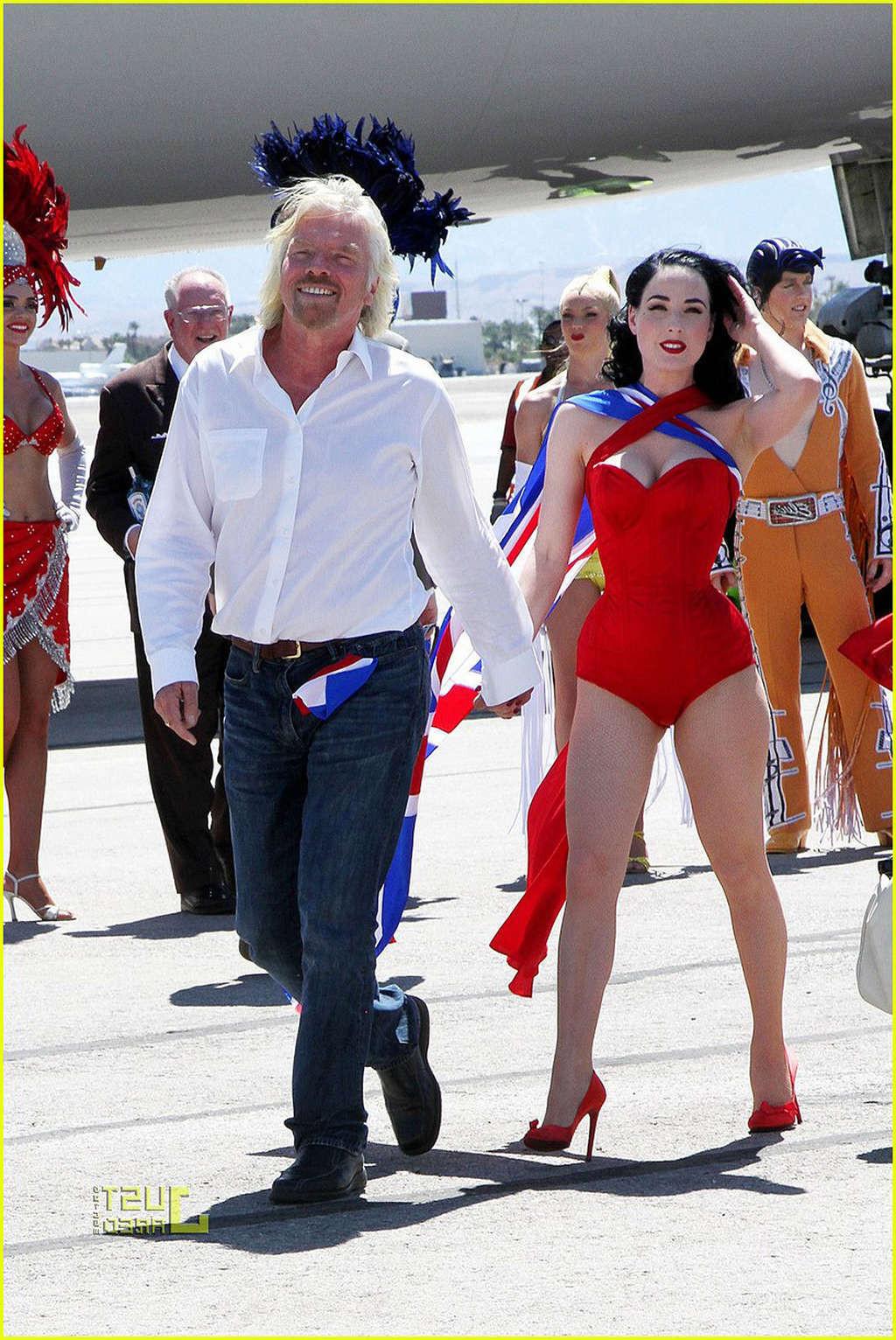 16P Dita Von Teese looking sexy in red outfit and exposing her tits