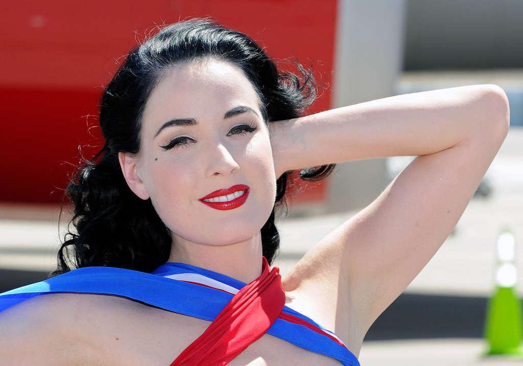16P Dita Von Teese looking sexy in red outfit and exposing her tits