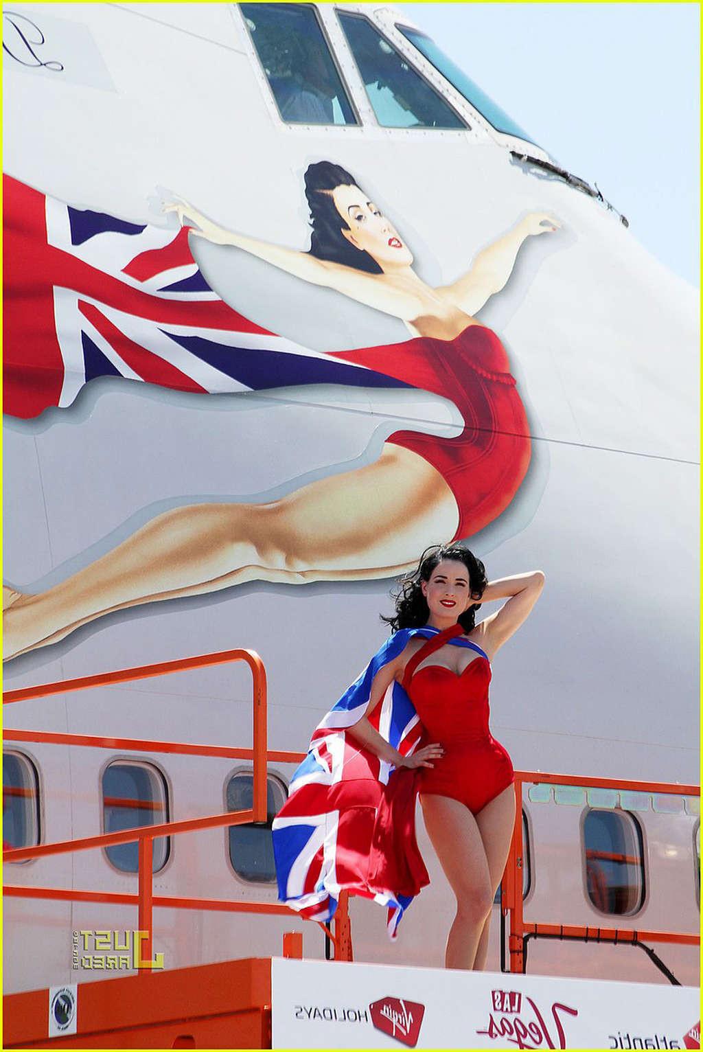 16P Dita Von Teese looking sexy in red outfit and exposing her tits