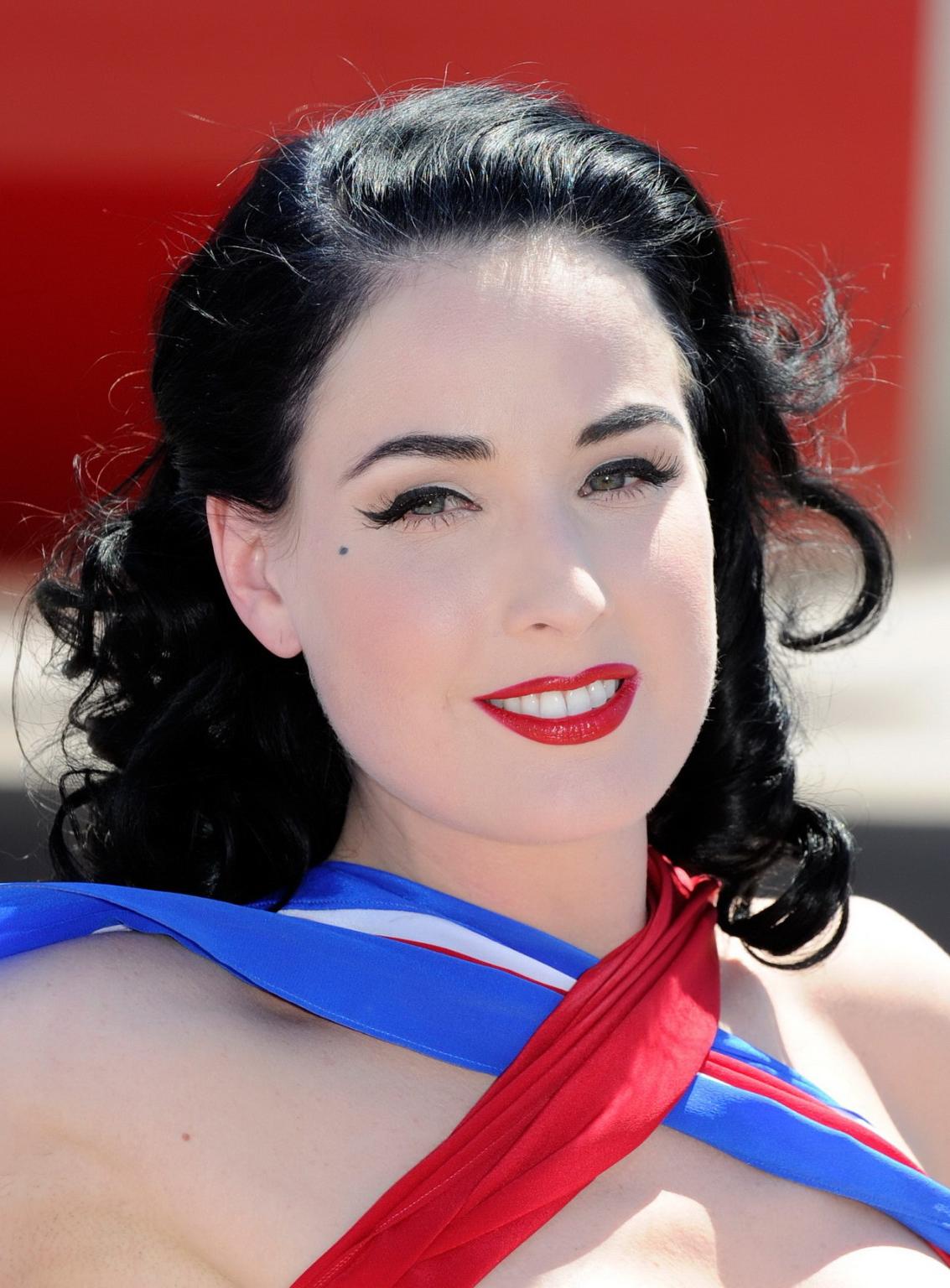 16P Dita Von Teese wearing red corset  fishnets at Virgin Atlantic's celebration