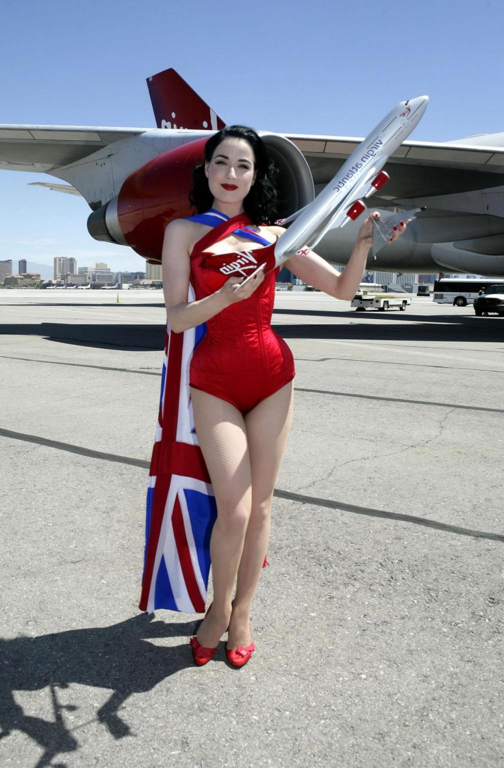 16P Dita Von Teese wearing red corset  fishnets at Virgin Atlantic's celebration