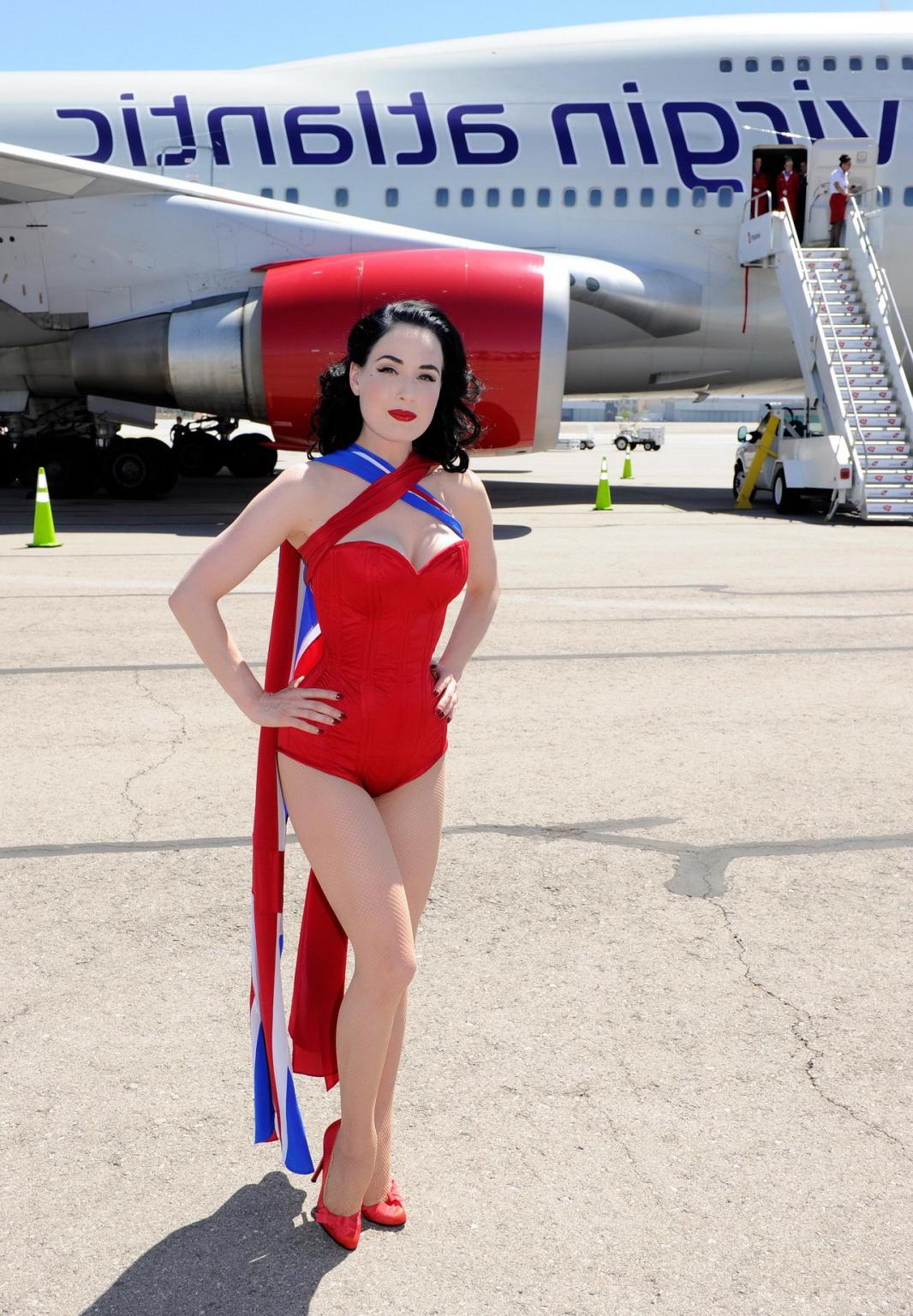 16P Dita Von Teese wearing red corset  fishnets at Virgin Atlantic's celebration