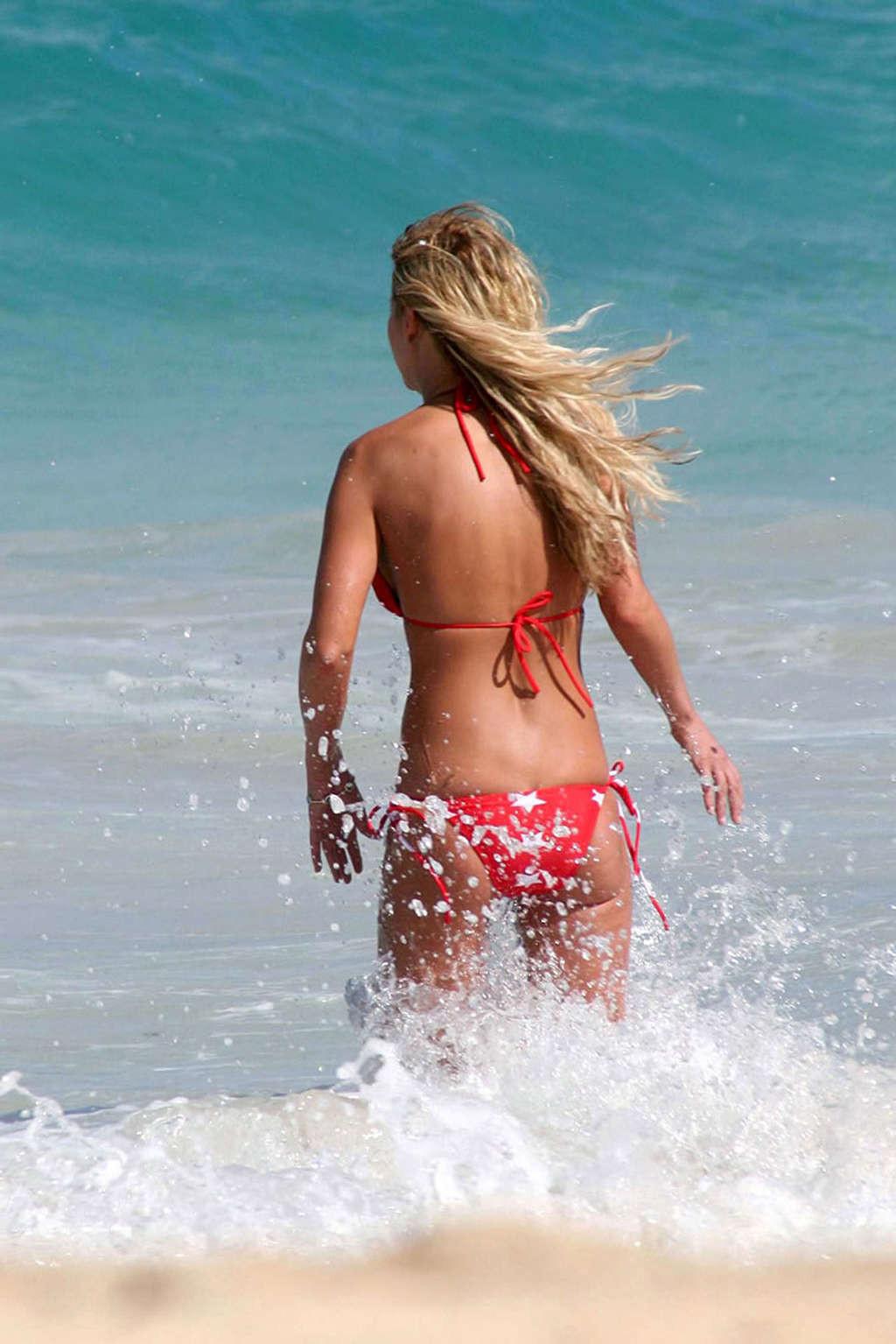 16P Tara Reid exposing her sexy body and huge tits in bikini on beach