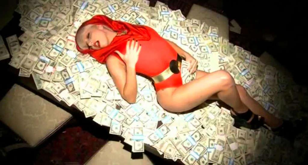 10P Lady Gaga posing very sexy and leggy on bed with money