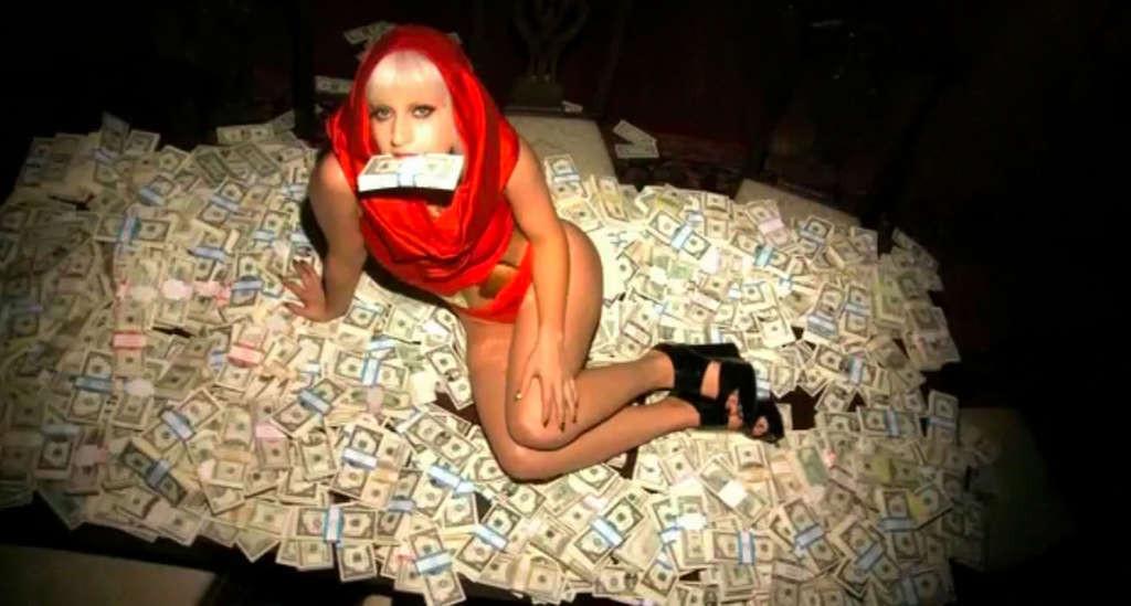 10P Lady Gaga posing very sexy and leggy on bed with money