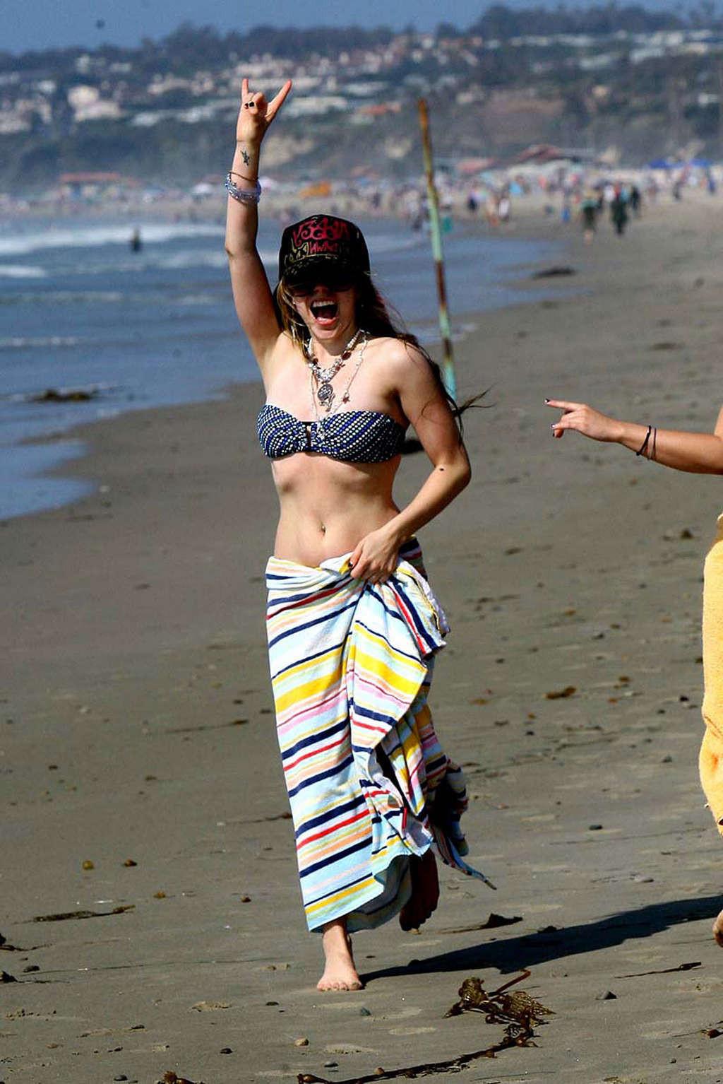 16P Avril Lavigne showing her sexy body and hot ass in bikini on beach