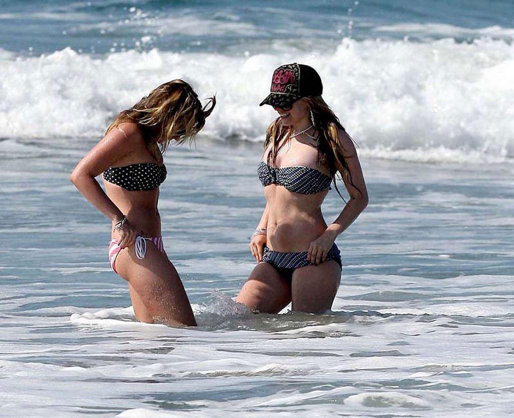16P Avril Lavigne showing her sexy body and hot ass in bikini on beach