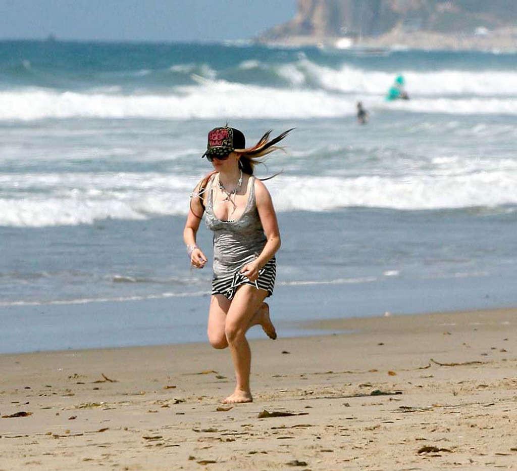 16P Avril Lavigne showing her sexy body and hot ass in bikini on beach