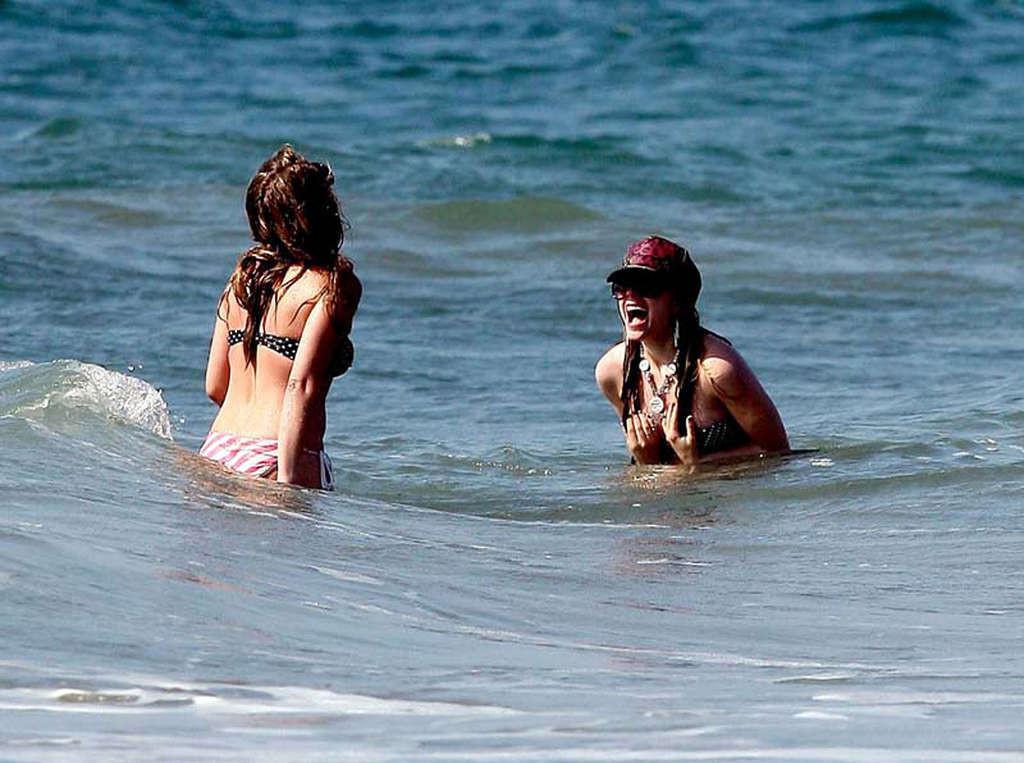 16P Avril Lavigne showing her sexy body and hot ass in bikini on beach