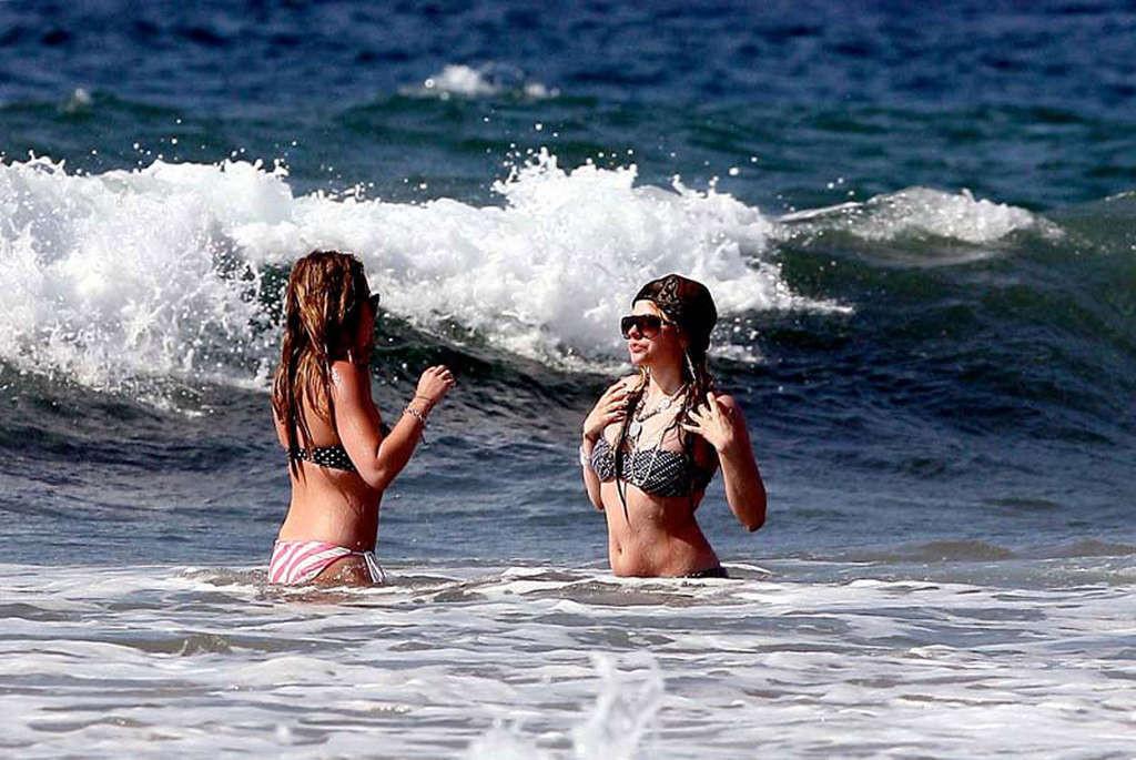 16P Avril Lavigne showing her sexy body and hot ass in bikini on beach