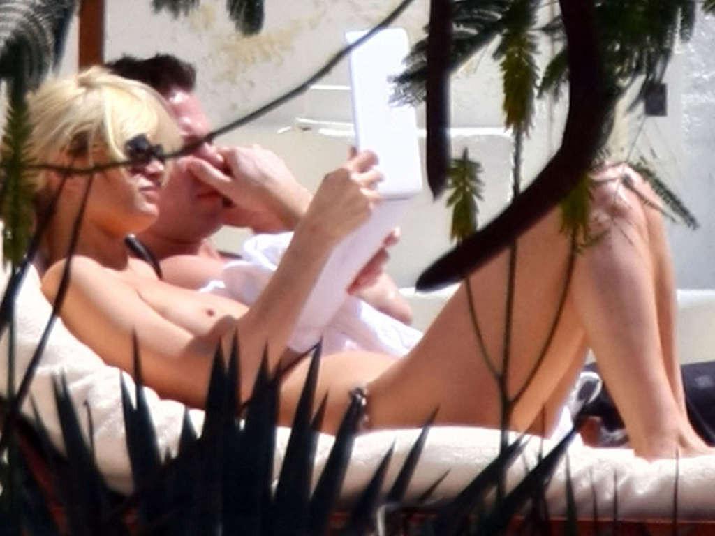 10P Paris Hilton showing her tits on vacation on while sunbathing paparazzi shoots