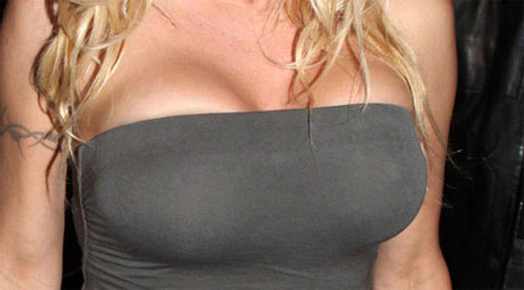 16P Pamela Anderson posing and showing her extremely huge boobs