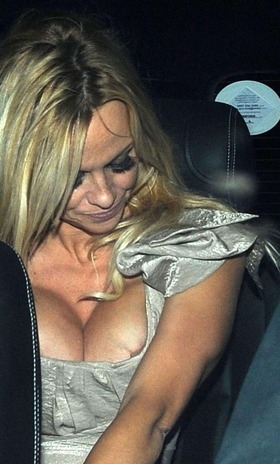 16P Pamela Anderson posing and showing her extremely huge boobs