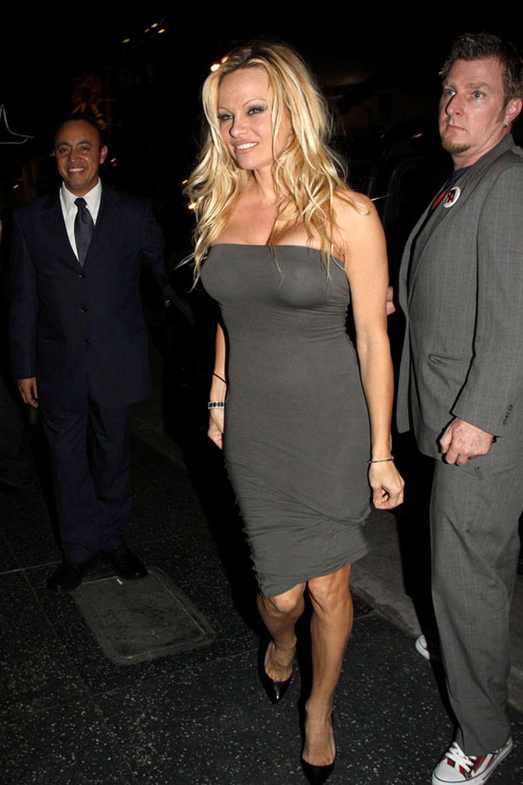 16P Pamela Anderson posing and showing her extremely huge boobs