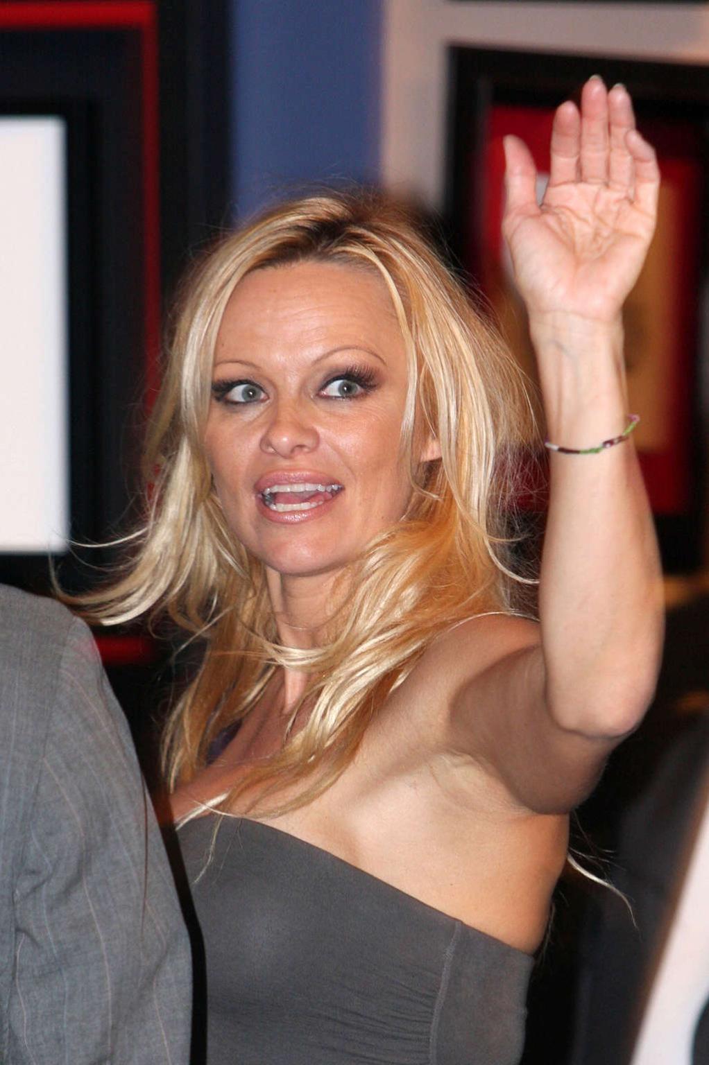 16P Pamela Anderson showing big cleavage and her nice tits and upskirt