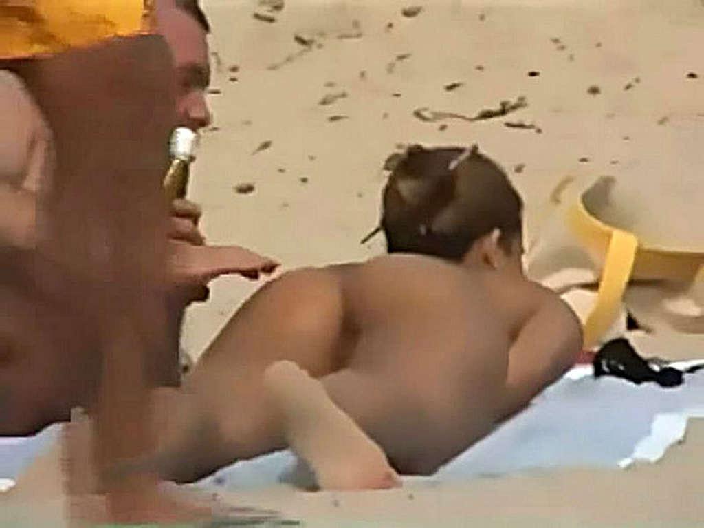 10P Clara Morgane exposing her nice big tits and pussy on beach