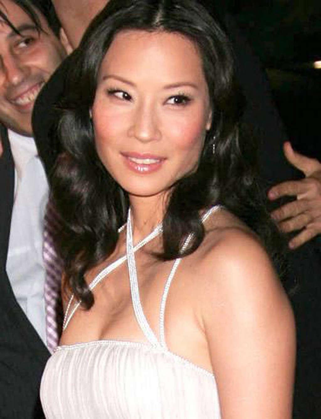 10P Lucy Liu exposing her nice tits and great legs in some photoshoot