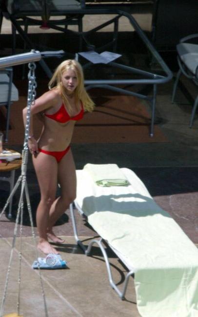15P sexy pop star Britney Spears stretching in a red thong bikini