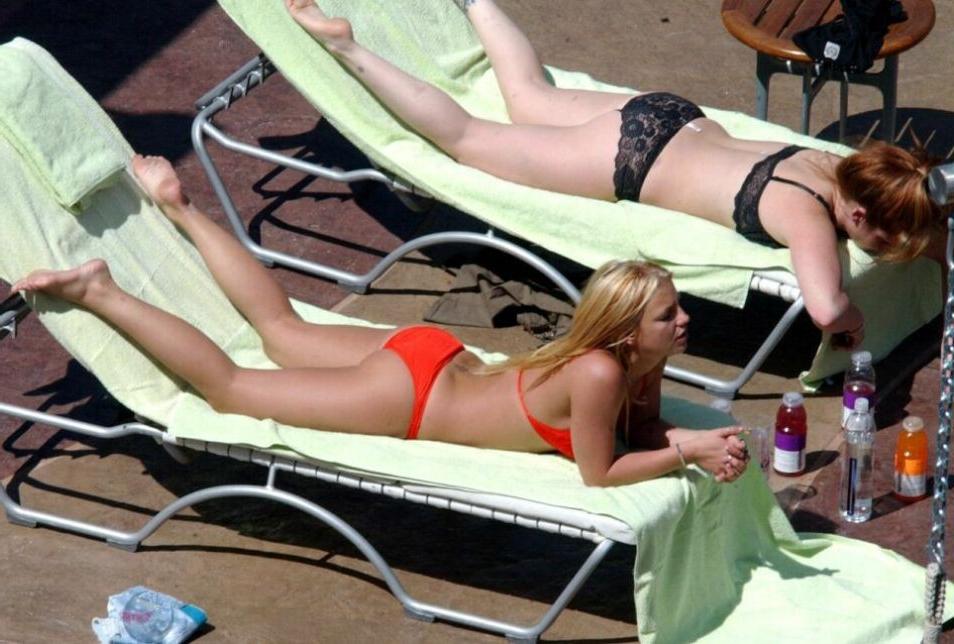 15P sexy pop star Britney Spears stretching in a red thong bikini